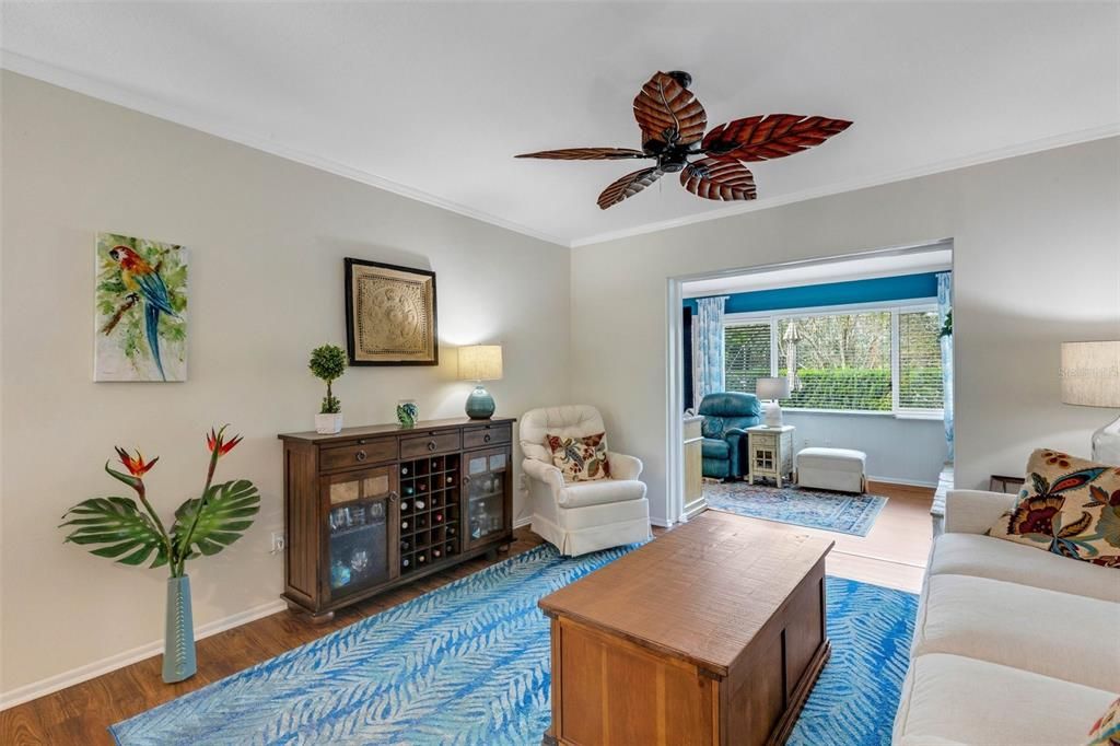 Light & bright living room with crown molding that opens to the sunny family room~