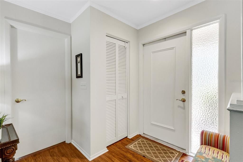 Welcoming entryway showcasing wood toned luxury vinyl flooring that flows seamlessly through the main living~