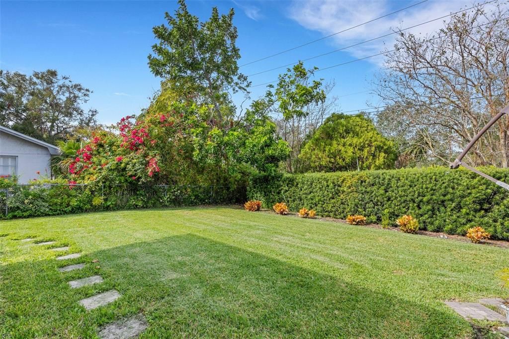 Private back yard with stepping stones around to the side garage door~