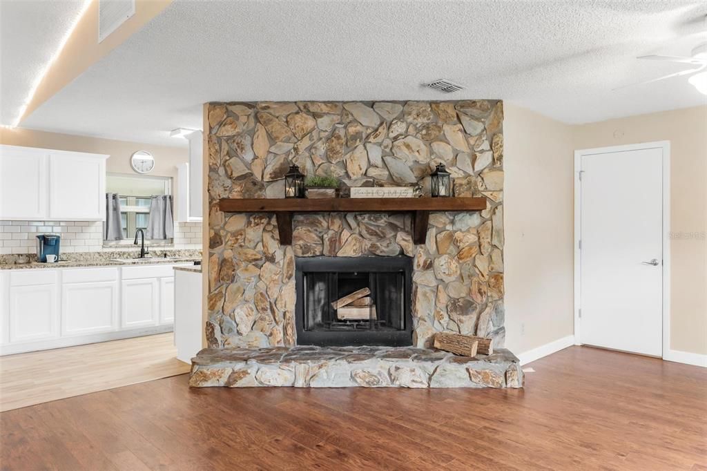 Wood-Burning Fireplace with a Wood Beam Mantle