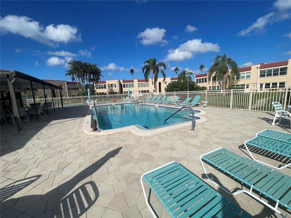 Beautiful pool lounge area with tables and umbrellas