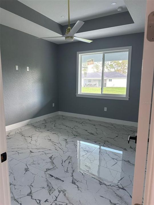 Primary bedroom with tray ceiling