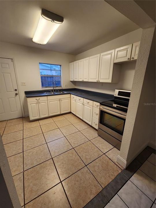 The very cozy kitchen right of the formal dining area