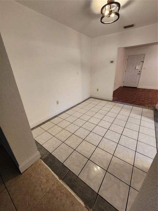 The formal dining area looking toward the front door with the kitchen on the right