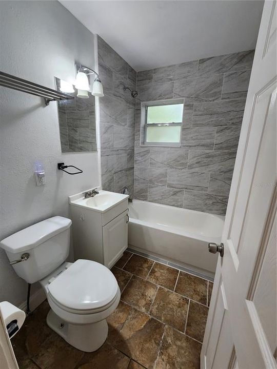 Remodeled bathroom between the primary bedroom and the front living room