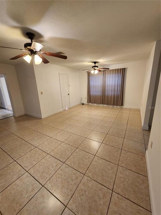 View of the large Family room with the dining area on the left and two bedrooms on the right