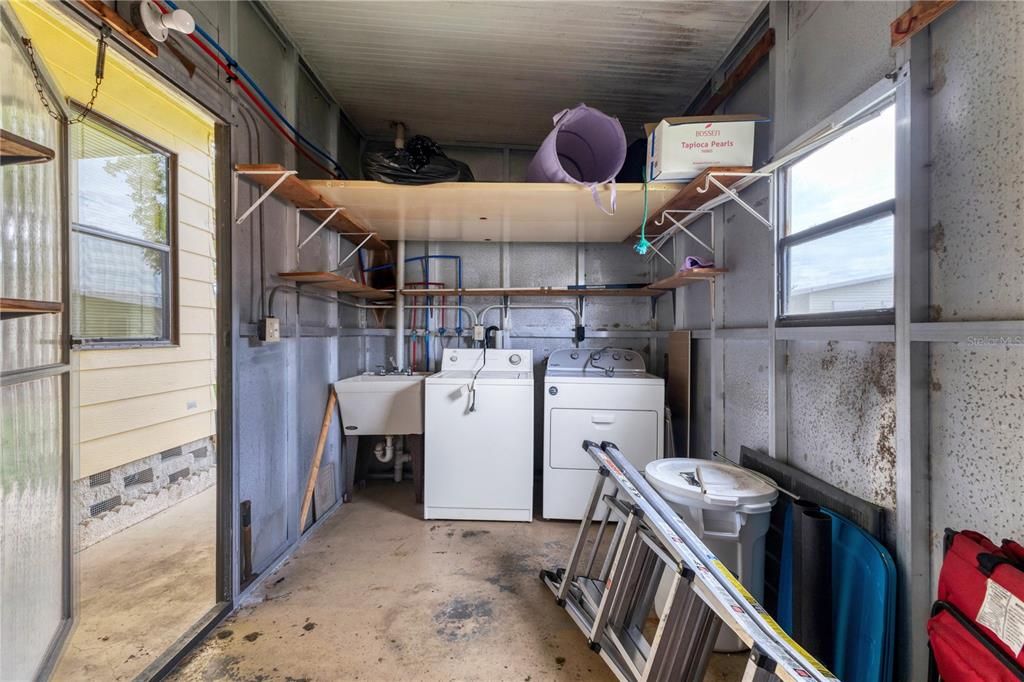 Shed features the washer, dryer, and sink.