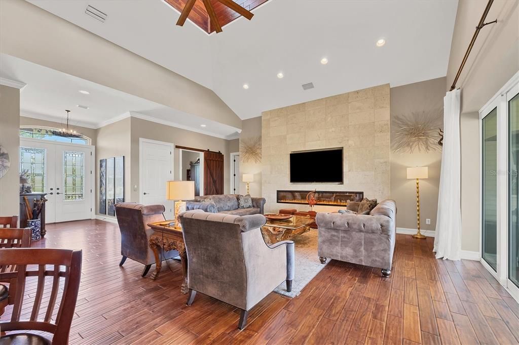 Living Room with Built-in area for TV, Electric Fireplace and 'Dominican  Coral Stone Wall.