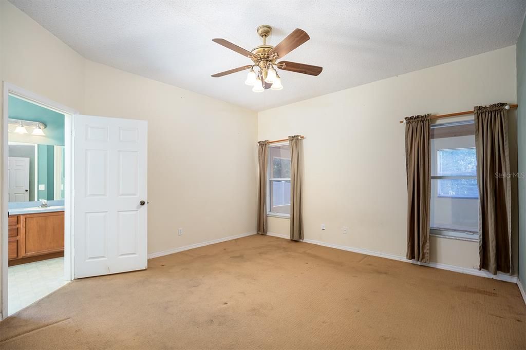 primary bedroom with view of bathroom