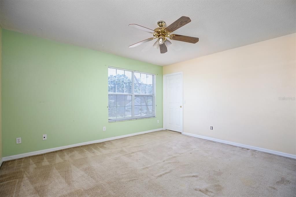 upstairs bedroom overlooking front of house with walk in closet