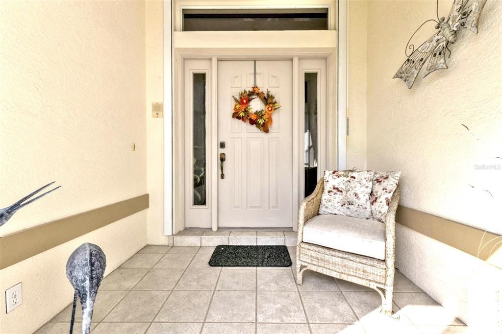 WELCOMING FRONT SCREENED PORCH AREA...GREAT PRIVATE AREA FOR DELIVERIES!