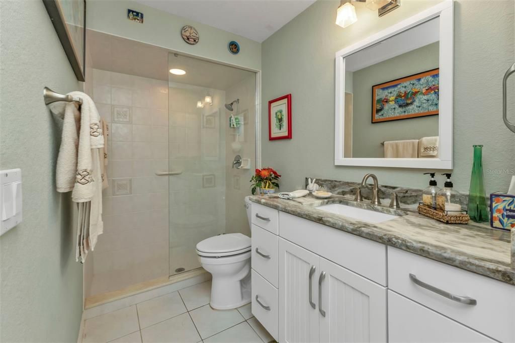 GUEST BATH WITH OVERSIZED VANITY, FANTASY BROWN TOP, SPACOUS TILED SHOWER, COMFORT HEIGHT TOILET