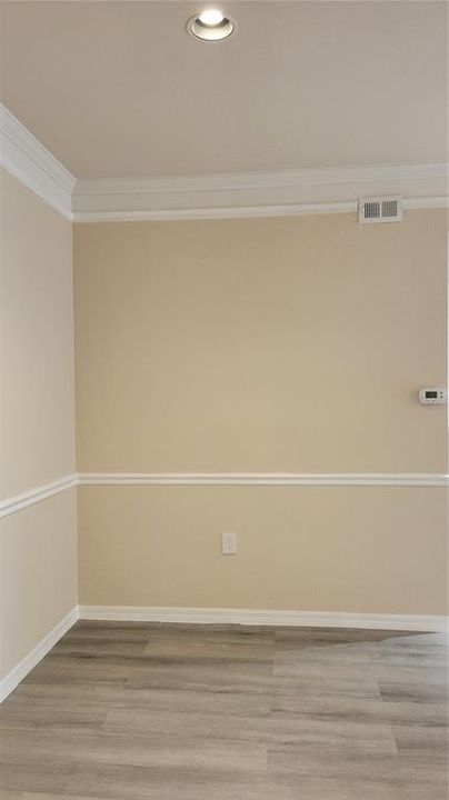 dining room with crown molding and chair rail