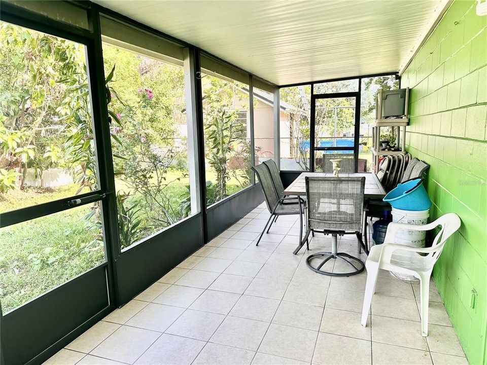 Large screened in porch with ceramic tile