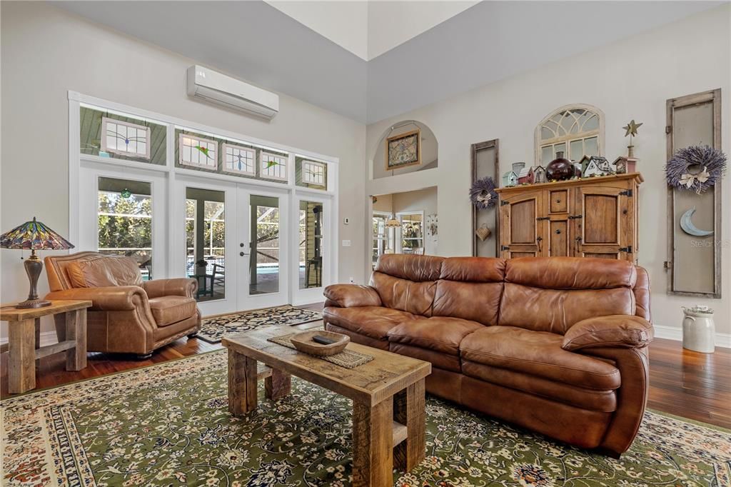 Living room with a split AC and French doors out to the lanai