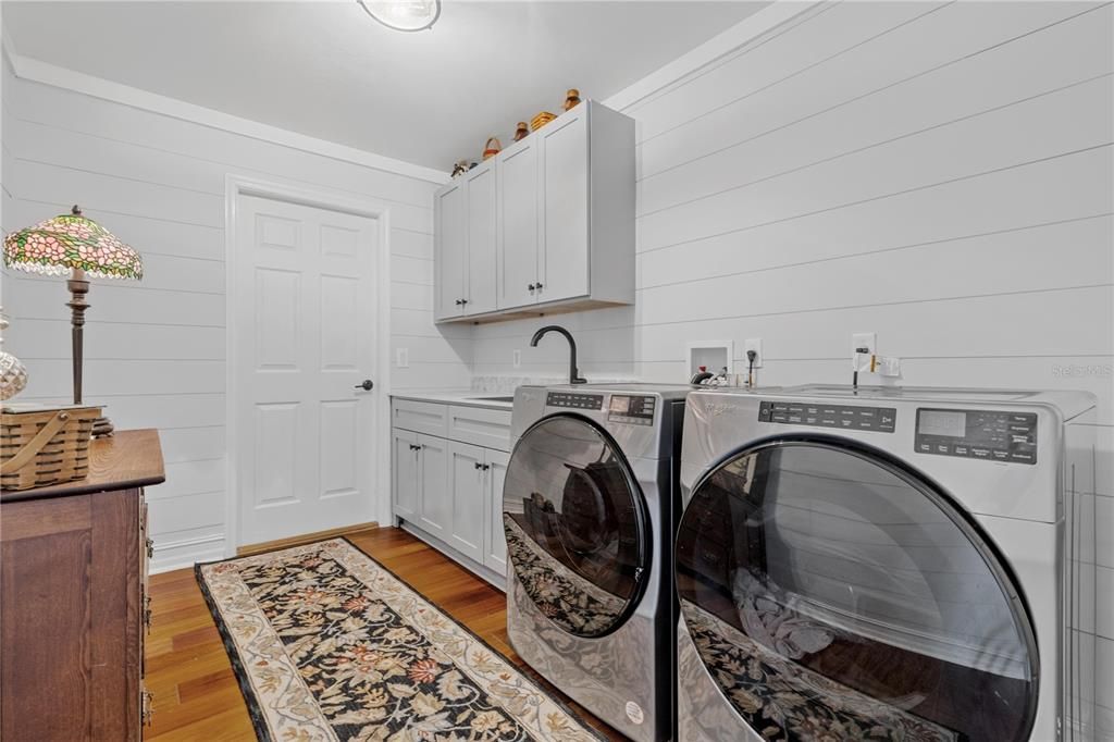 Super large and fancy laundry room with lots of storage.