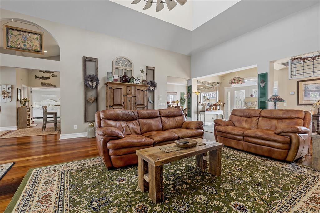 Living room featuring a towering ceiling, and plenty of natural light