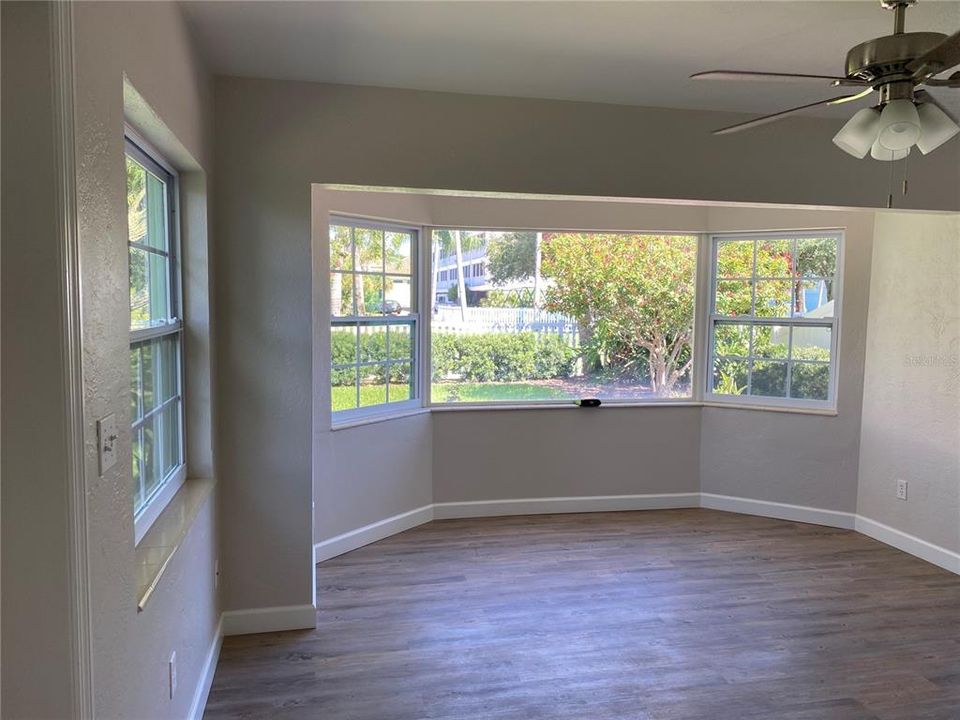 Unit 4 living room with bay window looking out to the park