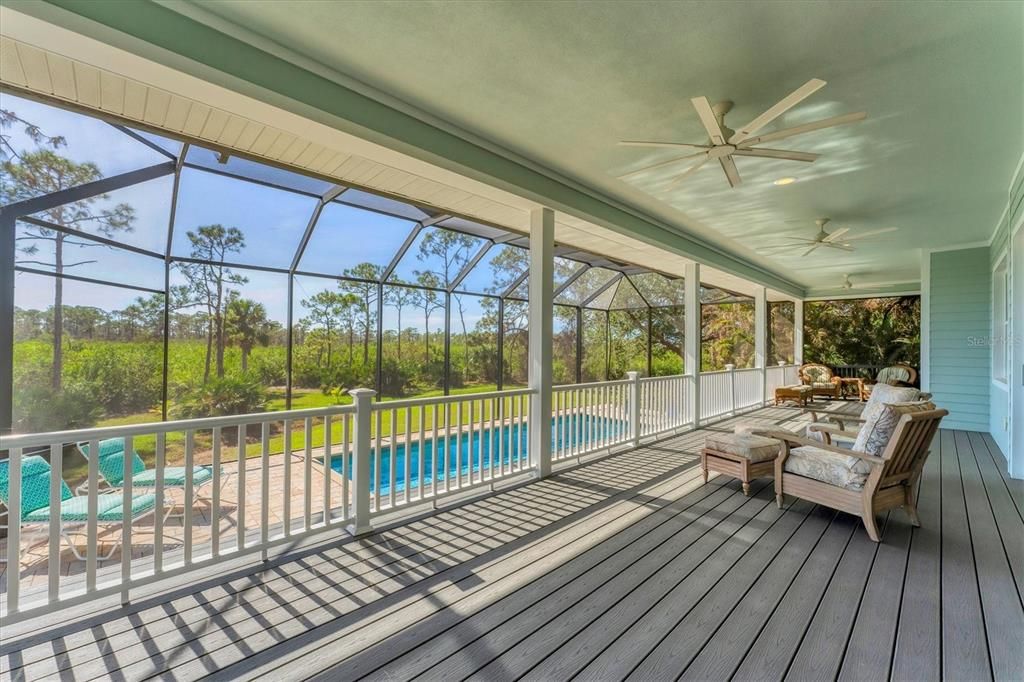 12' wide raised balcony overlooking pool lanai, yard, dock, firepit.