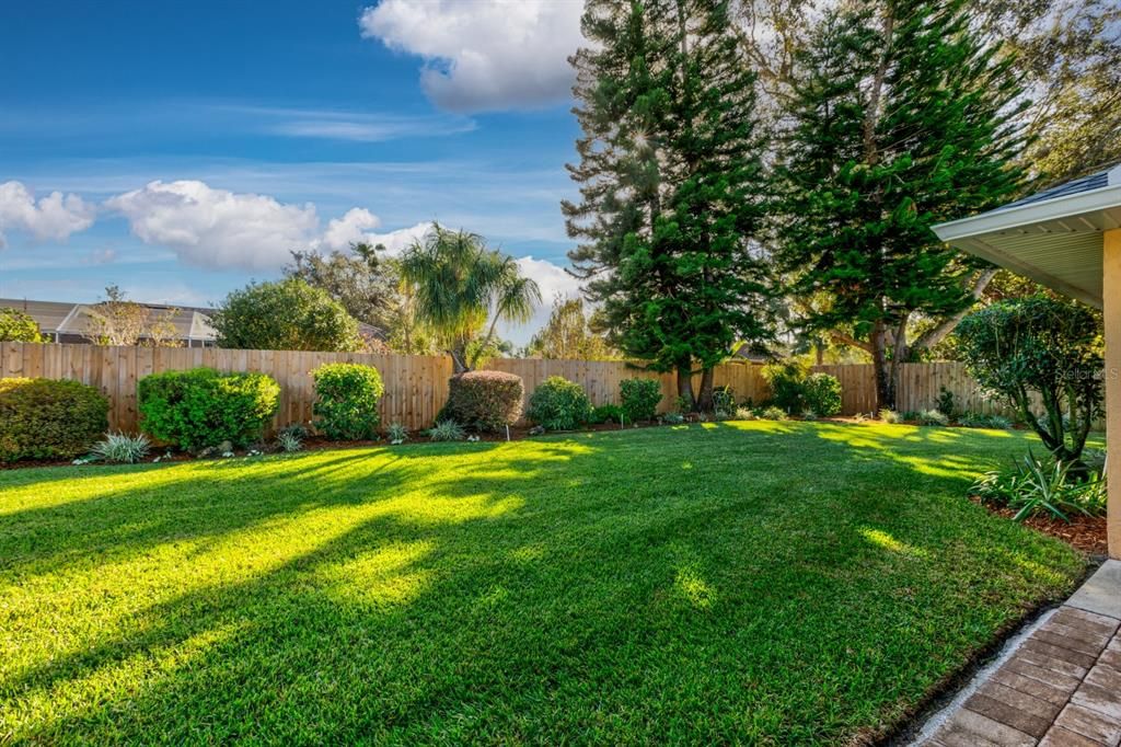 Backyard with mature landscaping maintained to perfection