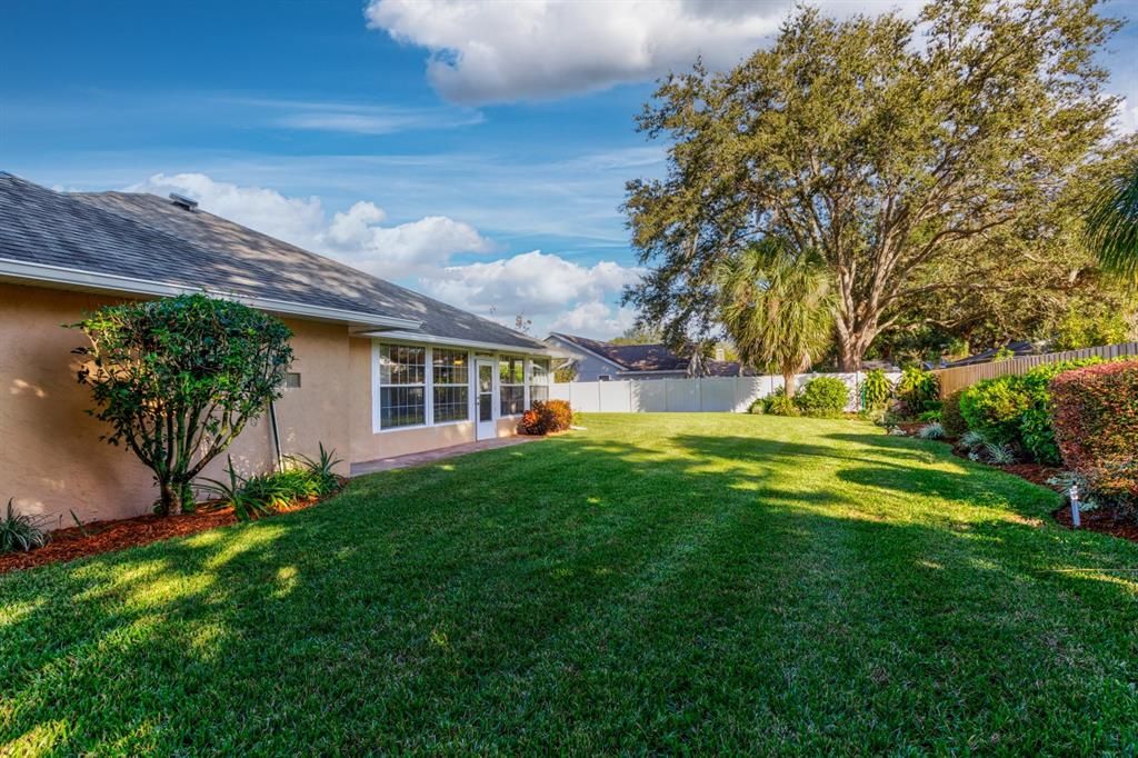 Backyard with mature landscaping maintained to perfection