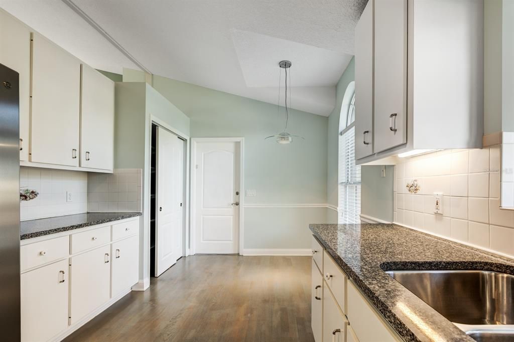 Kitchen with plenty of cabinets and closet pantry and beautiful stone counters