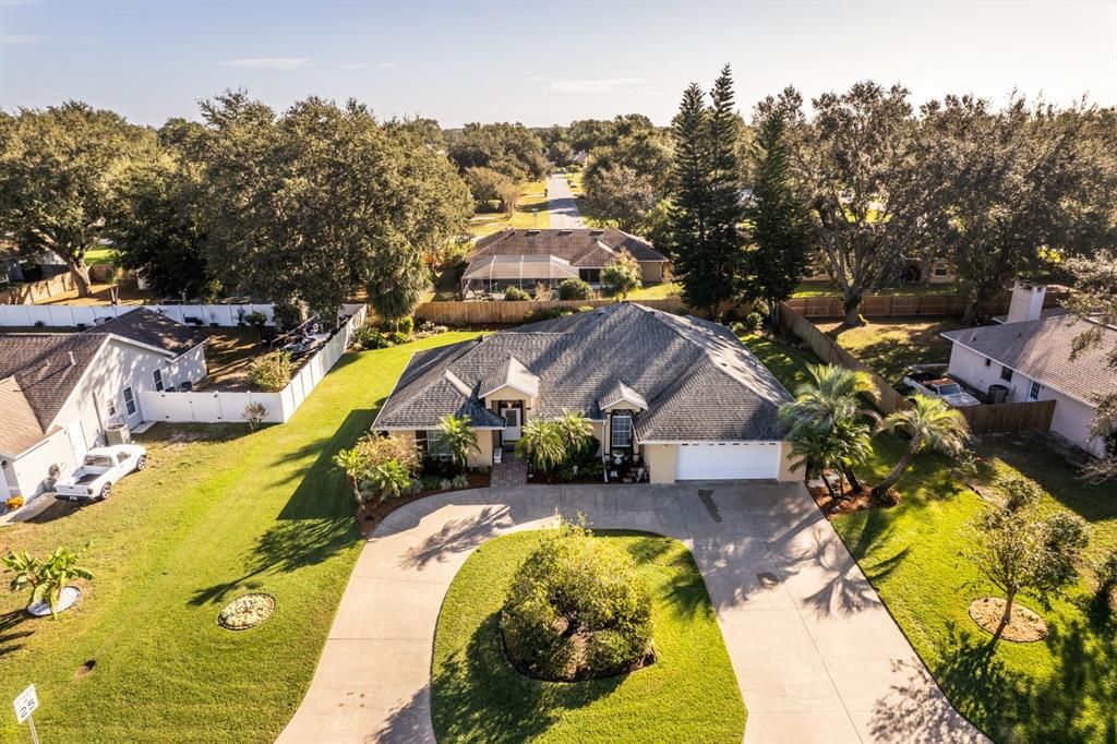 Ariel view from front showing the impeccable landscaping and circular drive for plenty of parking