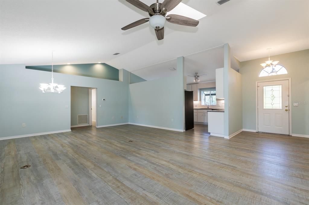 View of living room showing formal dining room area, kitchen entrance and foyer area