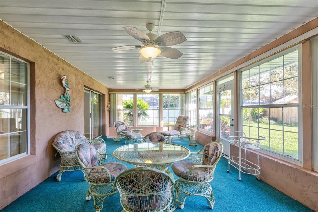 Glassed and air conditioned Florida room looking over beautifully landscaped backyard(entering from primary bedroom)