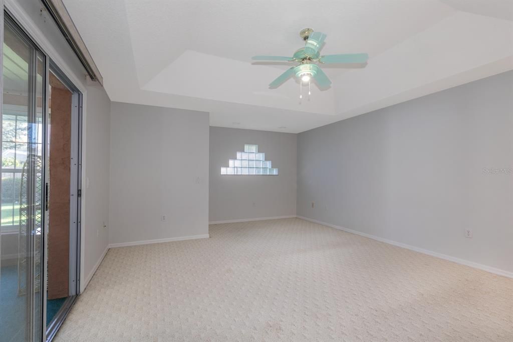 Primary bedroom with sitting nook area and access to air conditioned Florida room