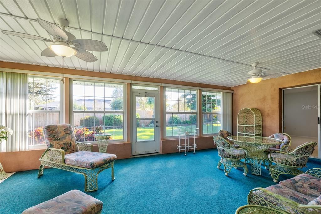 Glassed and air conditioned Florida room looking over beautifully landscaped backyard(entering from living room)