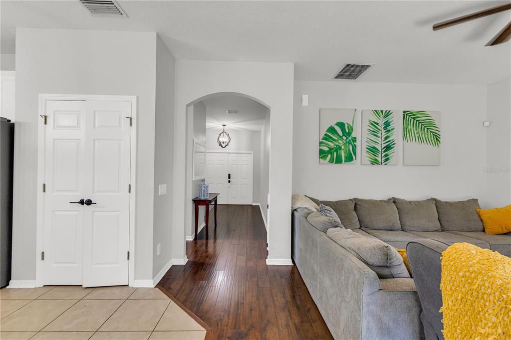 Living room to the right, kitchen to the left with double door pantry. Front door and dining room straight ahead.