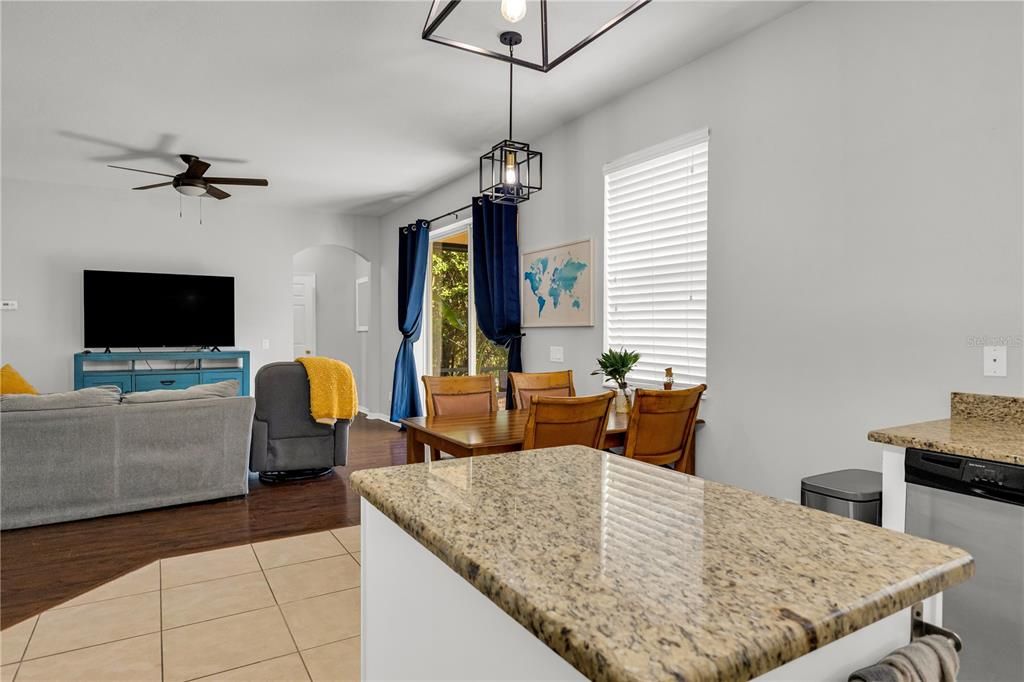 Kitchen going into the living room.  Sliding glass door to the right.