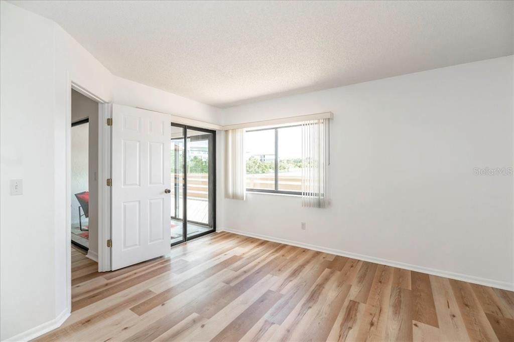 Primary bedroom - with a sliding glass door going out to the patio.