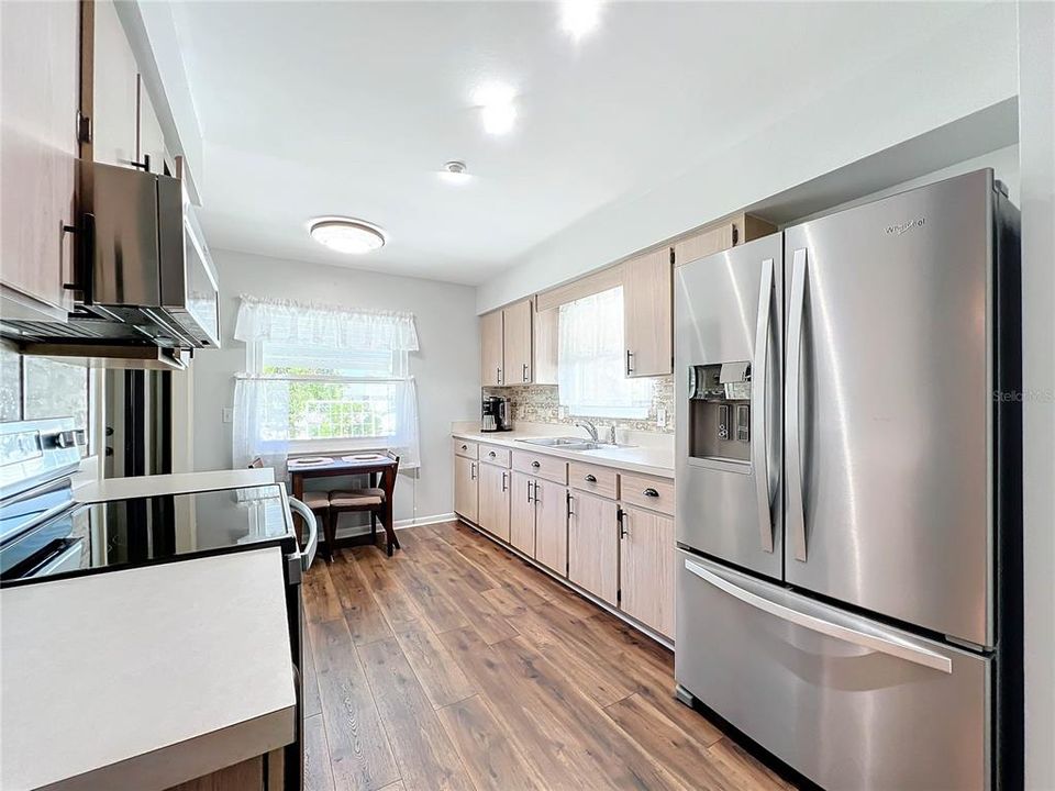 Spacious kitchen with stainless steel appliances.