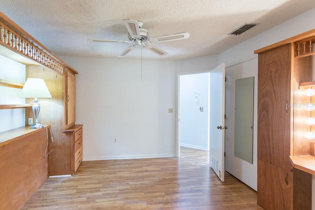 Primary bedroom and closet; lighted make-up station on right