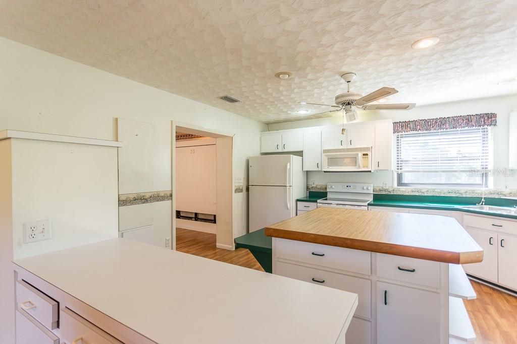 Kitchen, with built-in ironing board on left