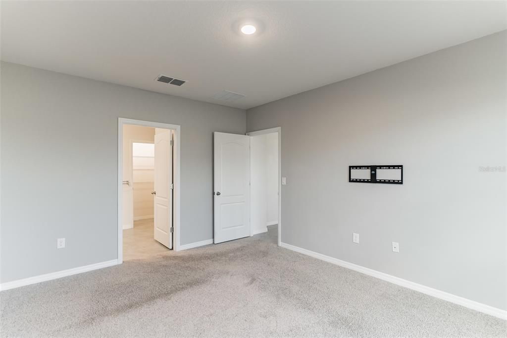 Owner's suite bedroom with ensuite bathroom and walk in closet.