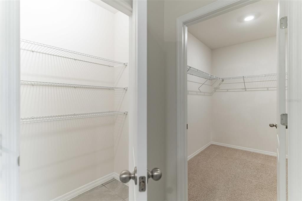 walk in closet and linen closet inside owner's suite bathroom