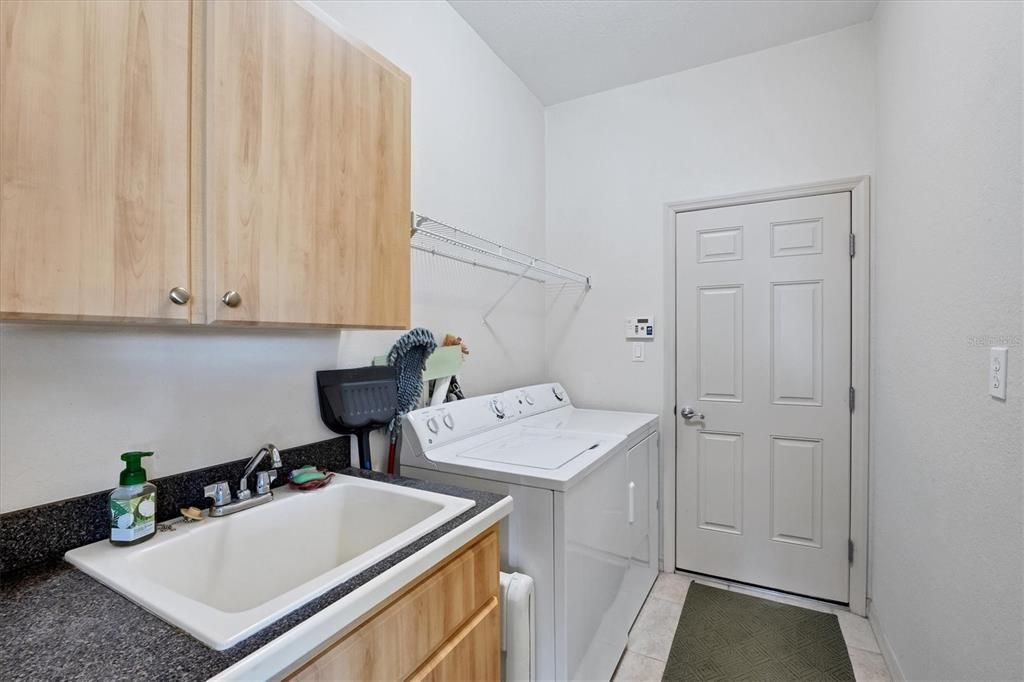 Laundry Room includes a utility sink & cabinets