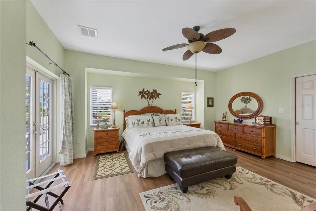 Master Suite has French doors extending directly to the pool and has canal views