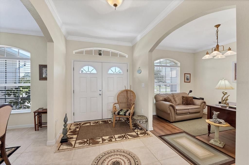 Foyer entry with Den/Office to the left and formal dining room to the right