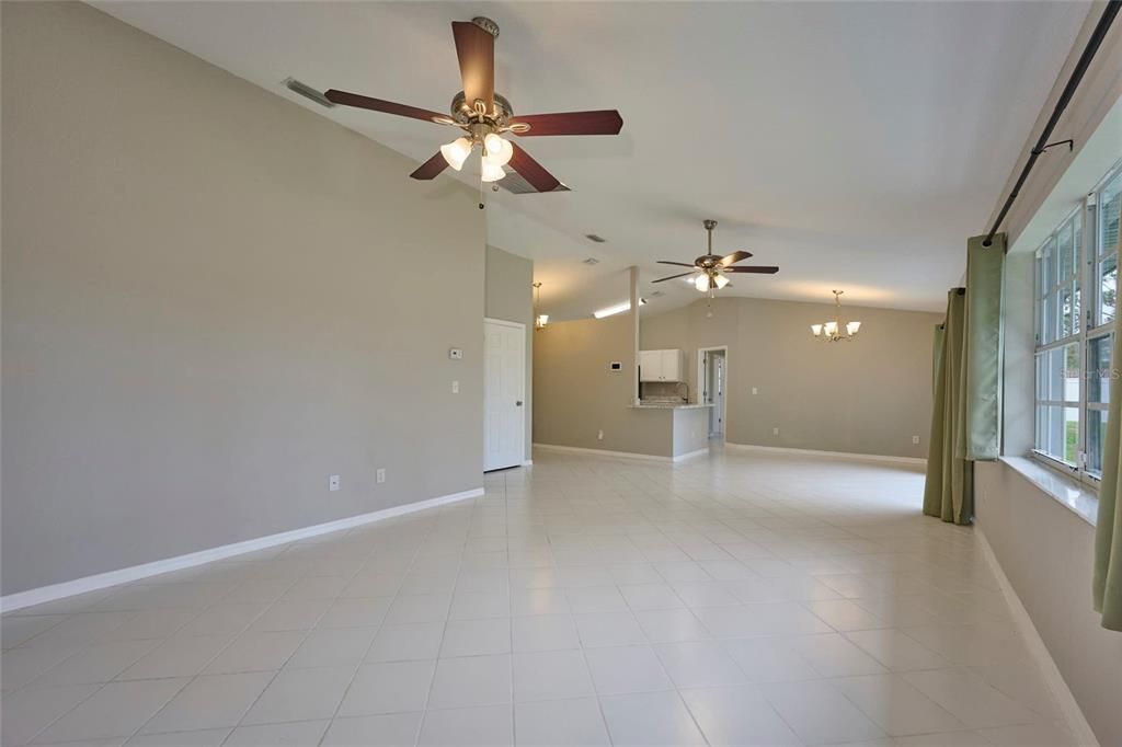 Living room in relation to kitchen and dining area.