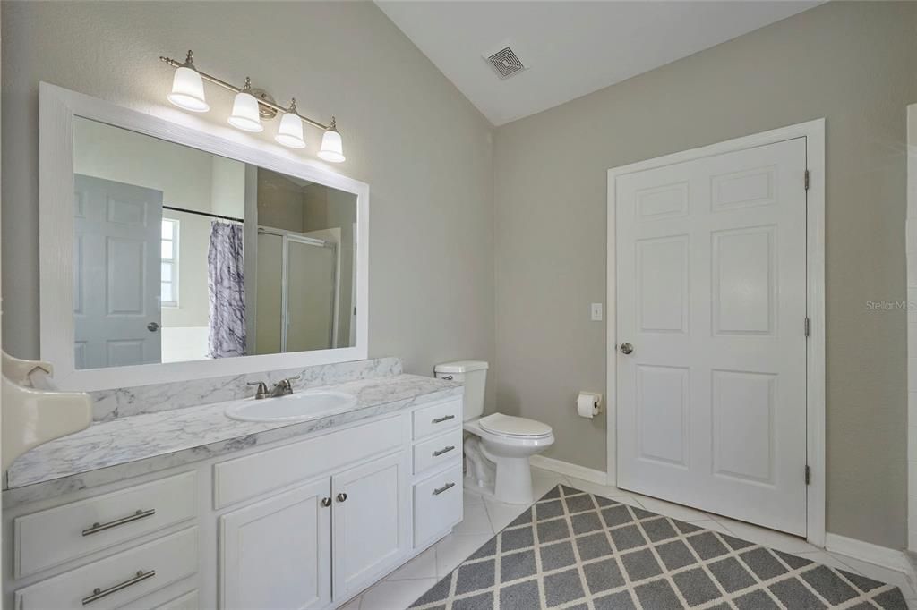 Vanity area in master bathroom.  Door opens to walk-in closet.