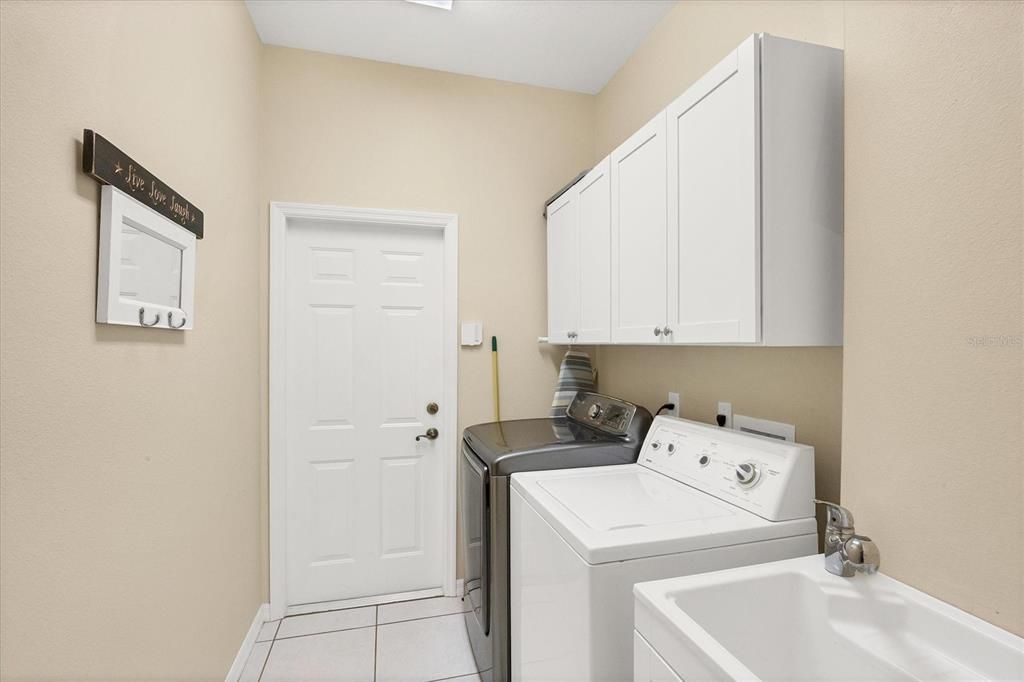 Laundry Room has a utility sink & added cabinetry