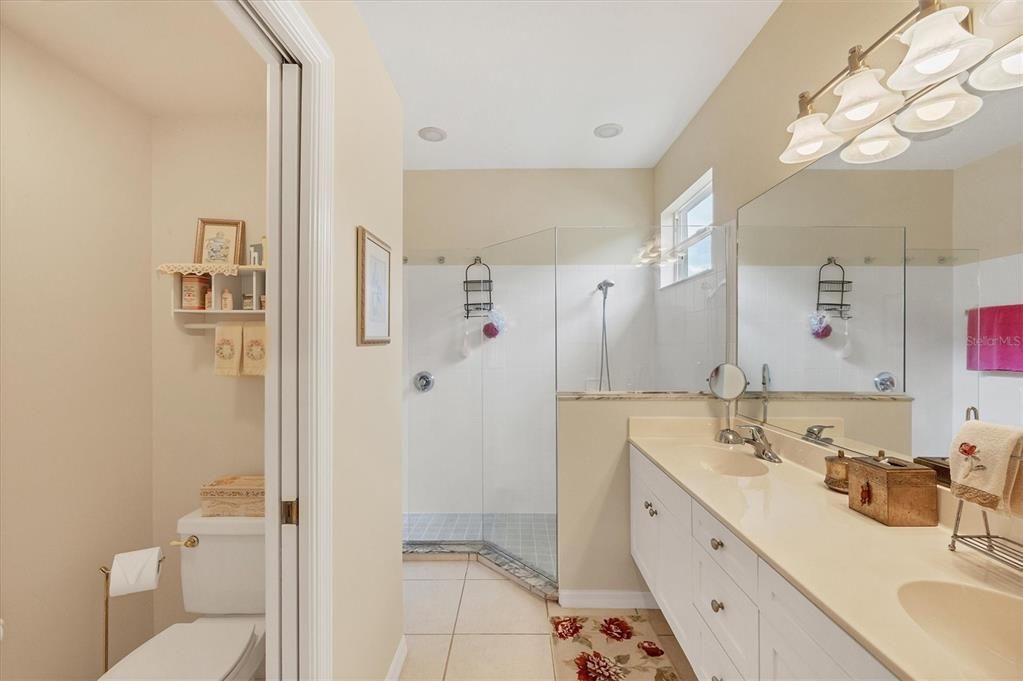 Master Bath provides a walk-in shower, dual sinks and separate commode