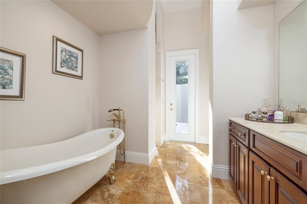 Second bath with private water closet in Primary bedroom suite. Shared shower overlooks the private outdoor spa.