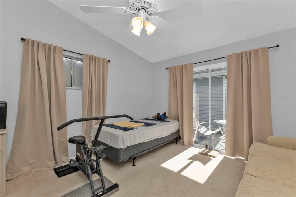 GUEST ROOM  WITH VAULTED CEILING AND SLIDER TO PORCH