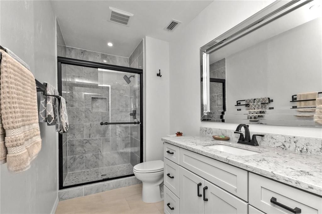 PRIMARY BATH, BEAUTIFUL TILED SHOWER WITH SHAMPOO NICHE, BRONZE HARDWARE, OVERSIZED VANITY WITH LOTS OF DRAWER SPACE