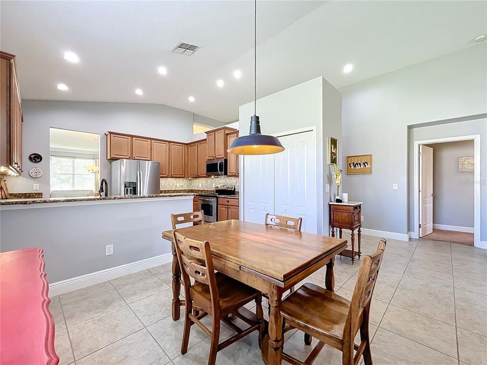 Eat in area looking into kitchen and primary bedroom entrance